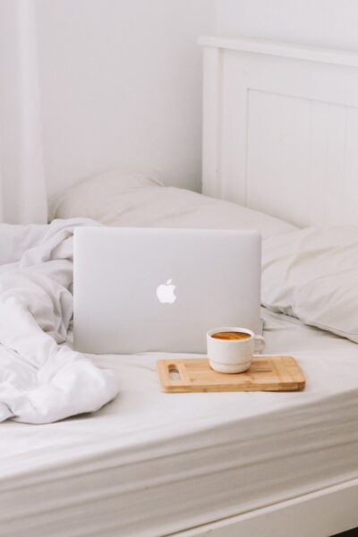 MacBook beside teacup with latte