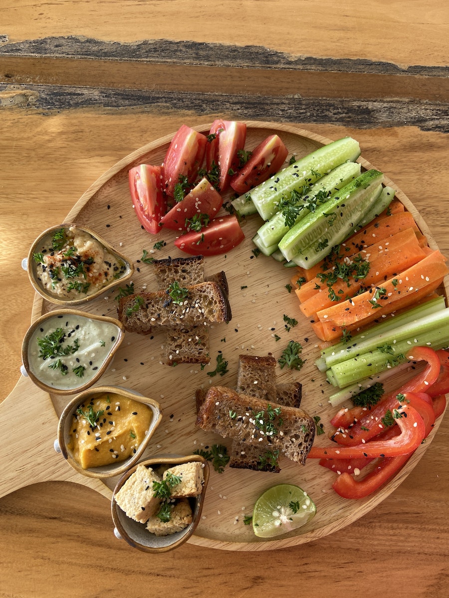 Sliced Assorted Vegetables and Bread on Brown Wooden Tray
